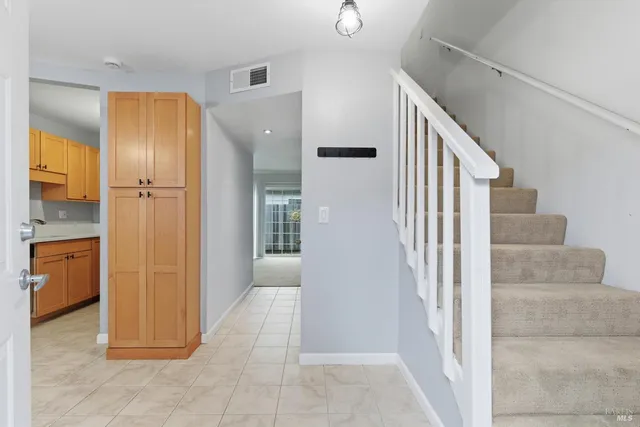 a bedroom with a bed a chair and a window