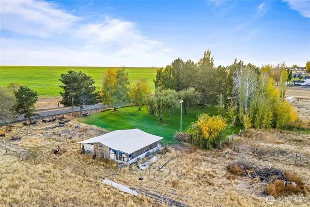 a kitchen with stainless steel appliances a dining table chairs stove refrigerator and cabinets