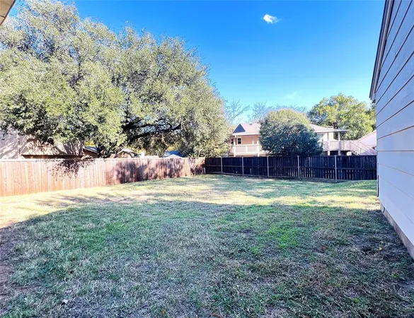 a view of a backyard with large trees