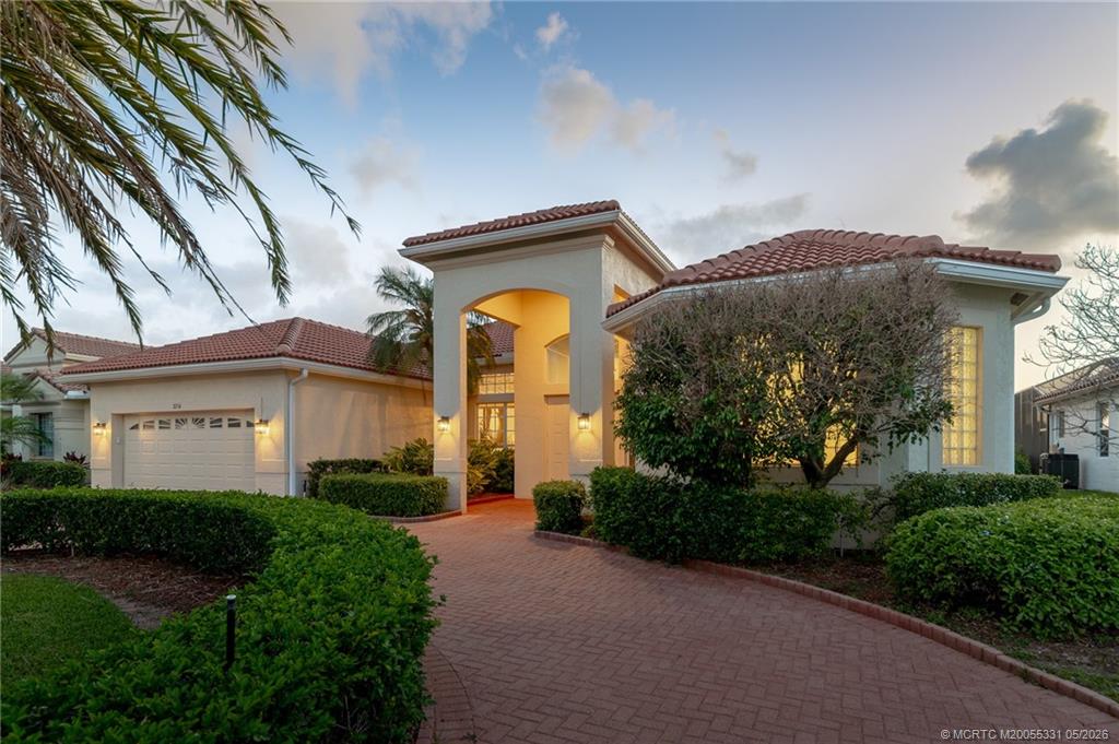 2216 Southeast Stonehaven Road Port St. Lucie, FL 34952 - Photo 2 of 67 a front view of a house with garden