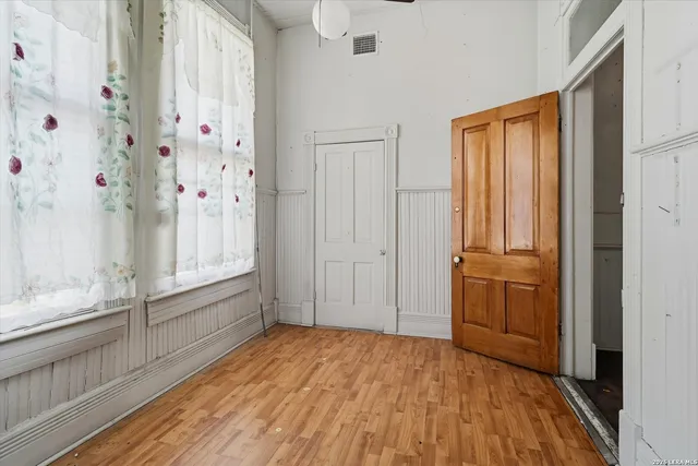 a view of an entryway with wooden floors