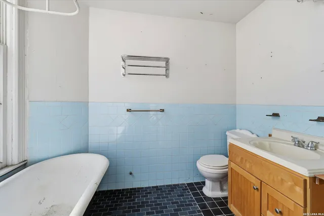 a bathroom with a sink mirror and toilet