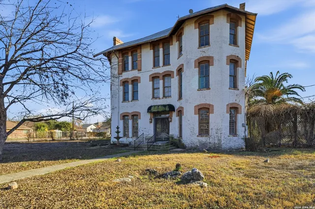 an aerial view of a house with a yard basket ball court and outdoor seating