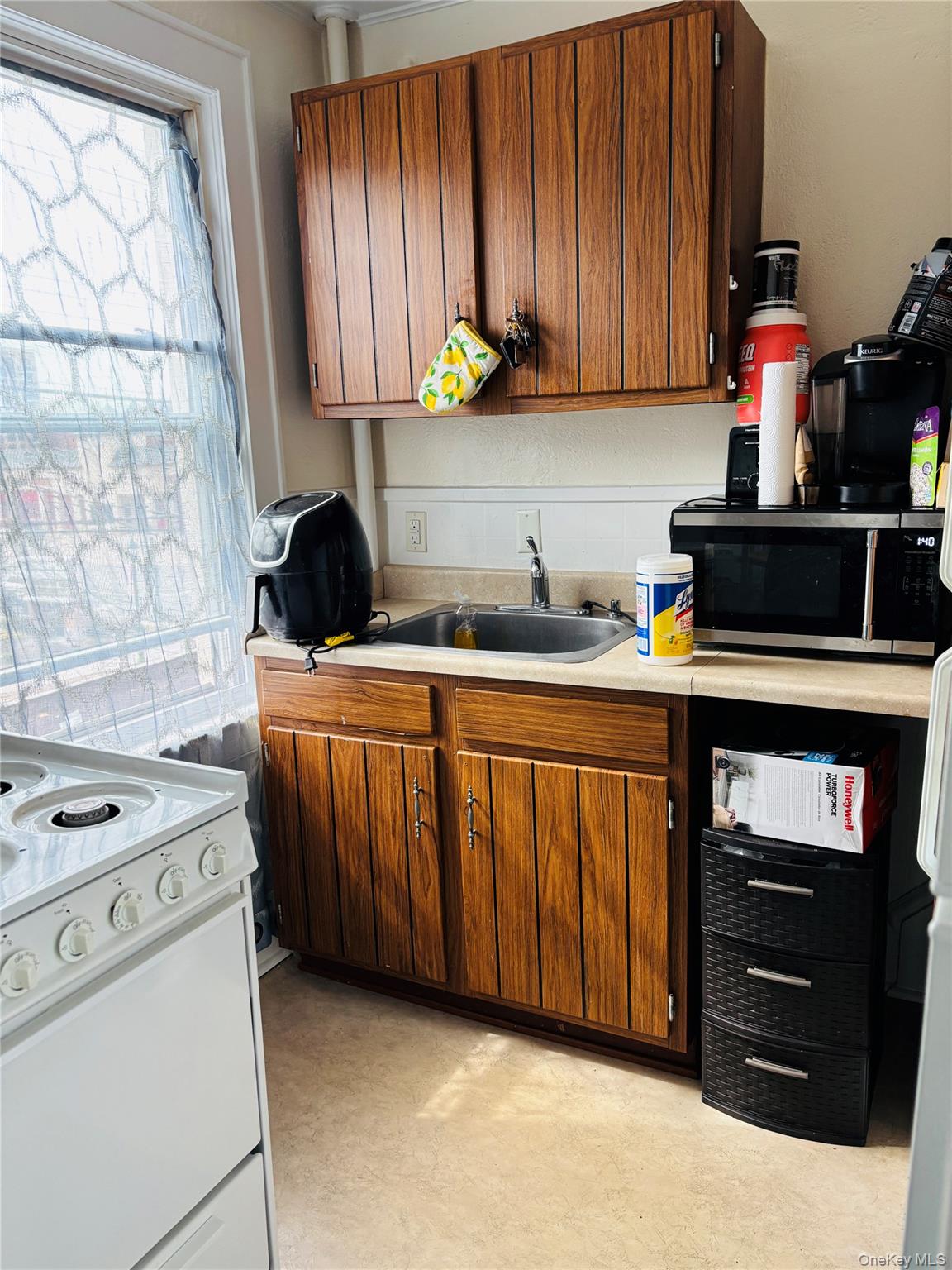 1206 Main Street Peekskill, NY 10566 - Photo 17 of 59 a kitchen with stainless steel appliances a stove a sink and a refrigerator