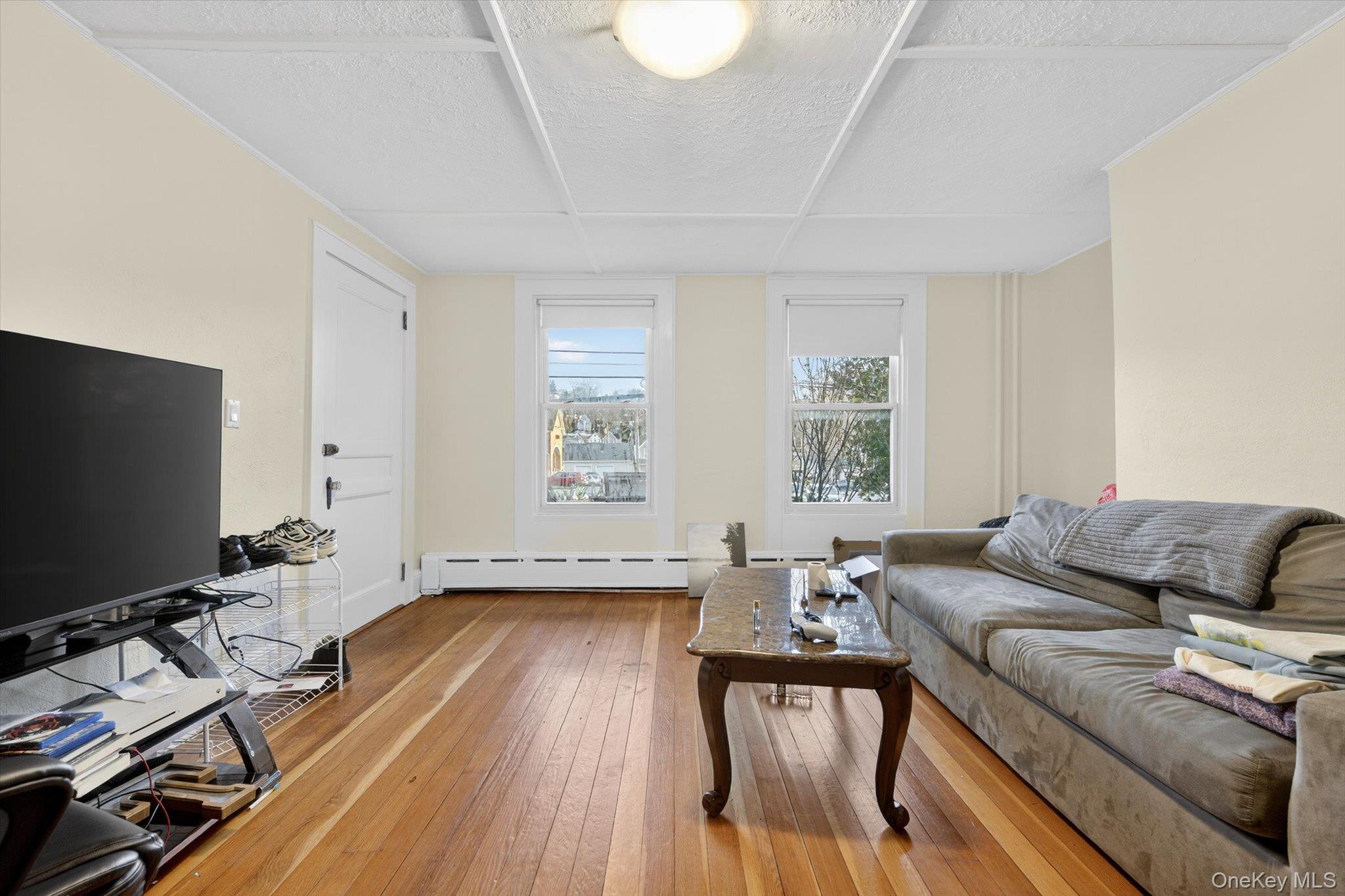 1206 Main Street Peekskill, NY 10566 - Photo 24 of 59 a living room with furniture and a flat screen tv