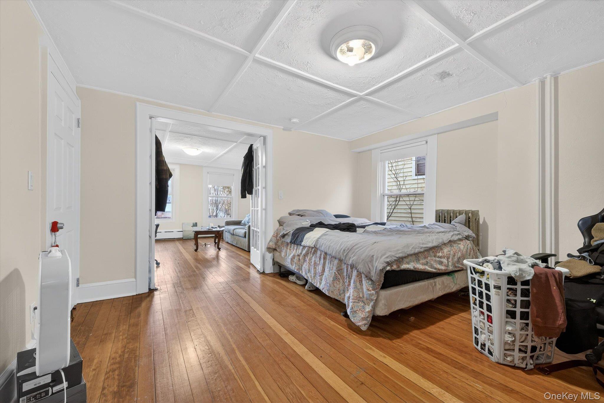 1206 Main Street Peekskill, NY 10566 - Photo 26 of 59 a bedroom with a bed and wooden floor