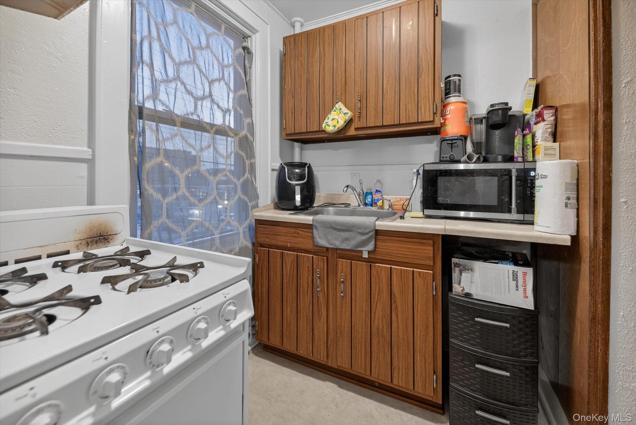 1206 Main Street Peekskill, NY 10566 - Photo 52 of 59 a kitchen with stainless steel appliances granite countertop a stove and a microwave