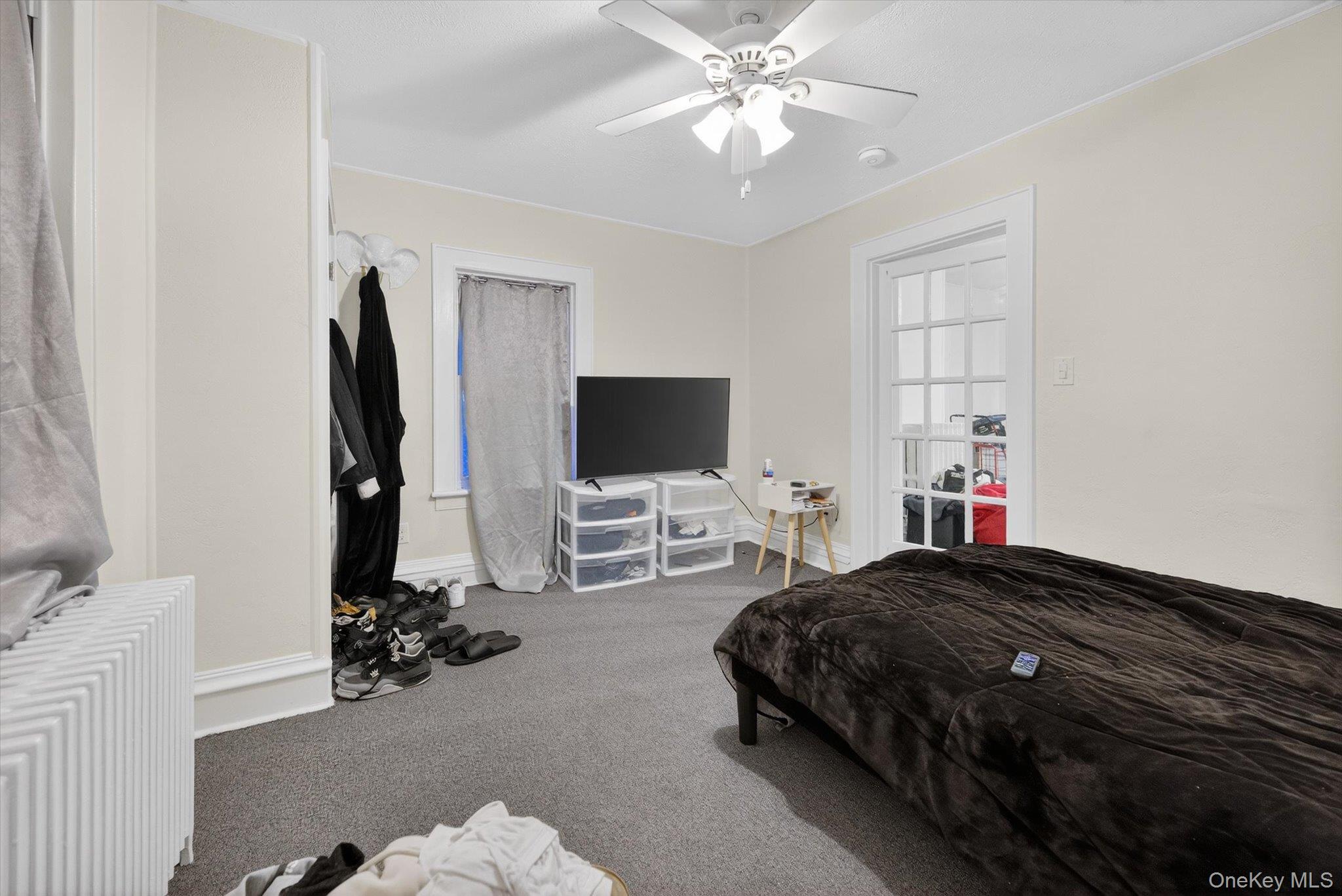 1206 Main Street Peekskill, NY 10566 - Photo 55 of 59 a bedroom with a bed and a flat screen tv