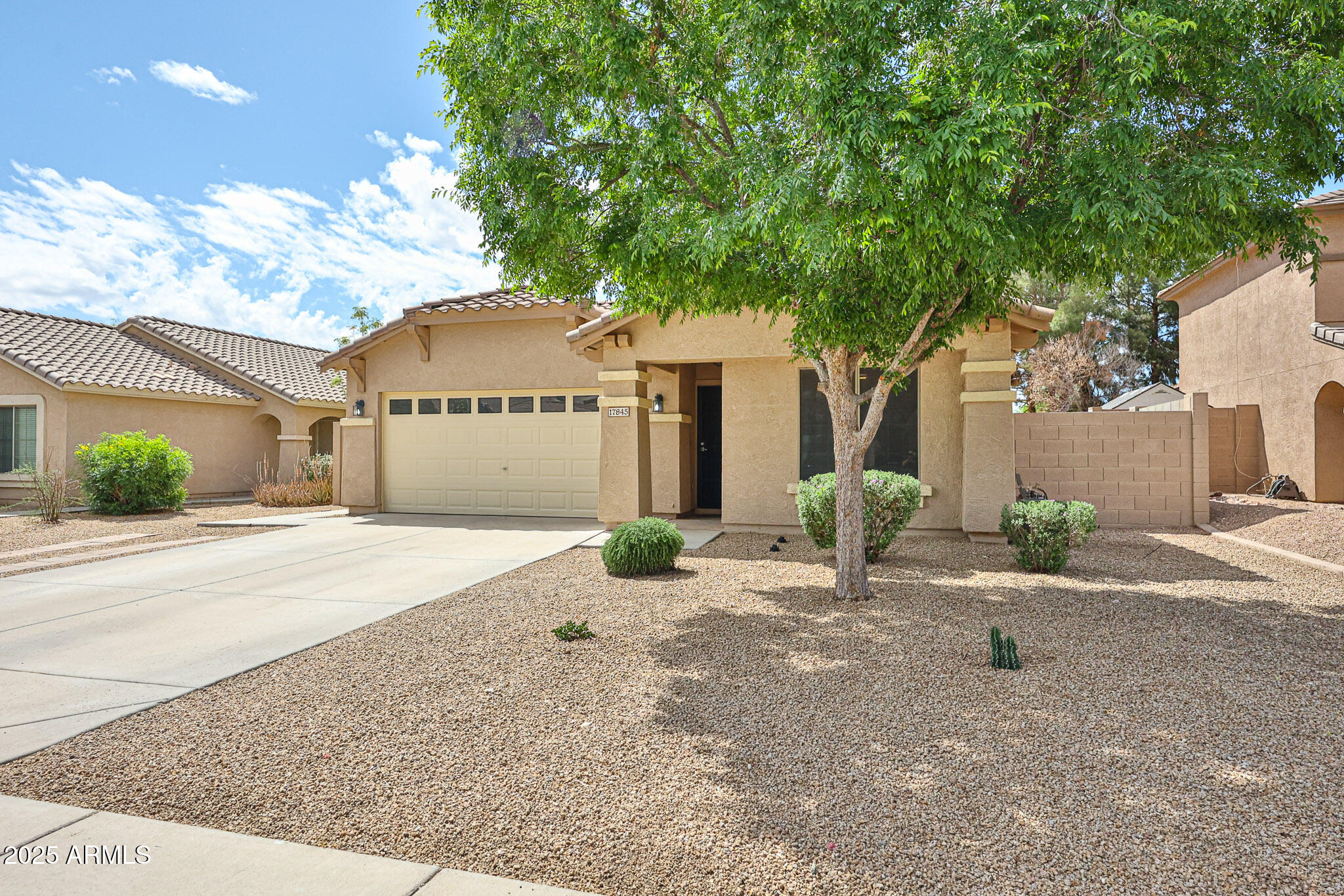 17845 West Calavar Road Surprise, AZ 85388 - Photo 21 of 26 a front view of a house with a yard and garage