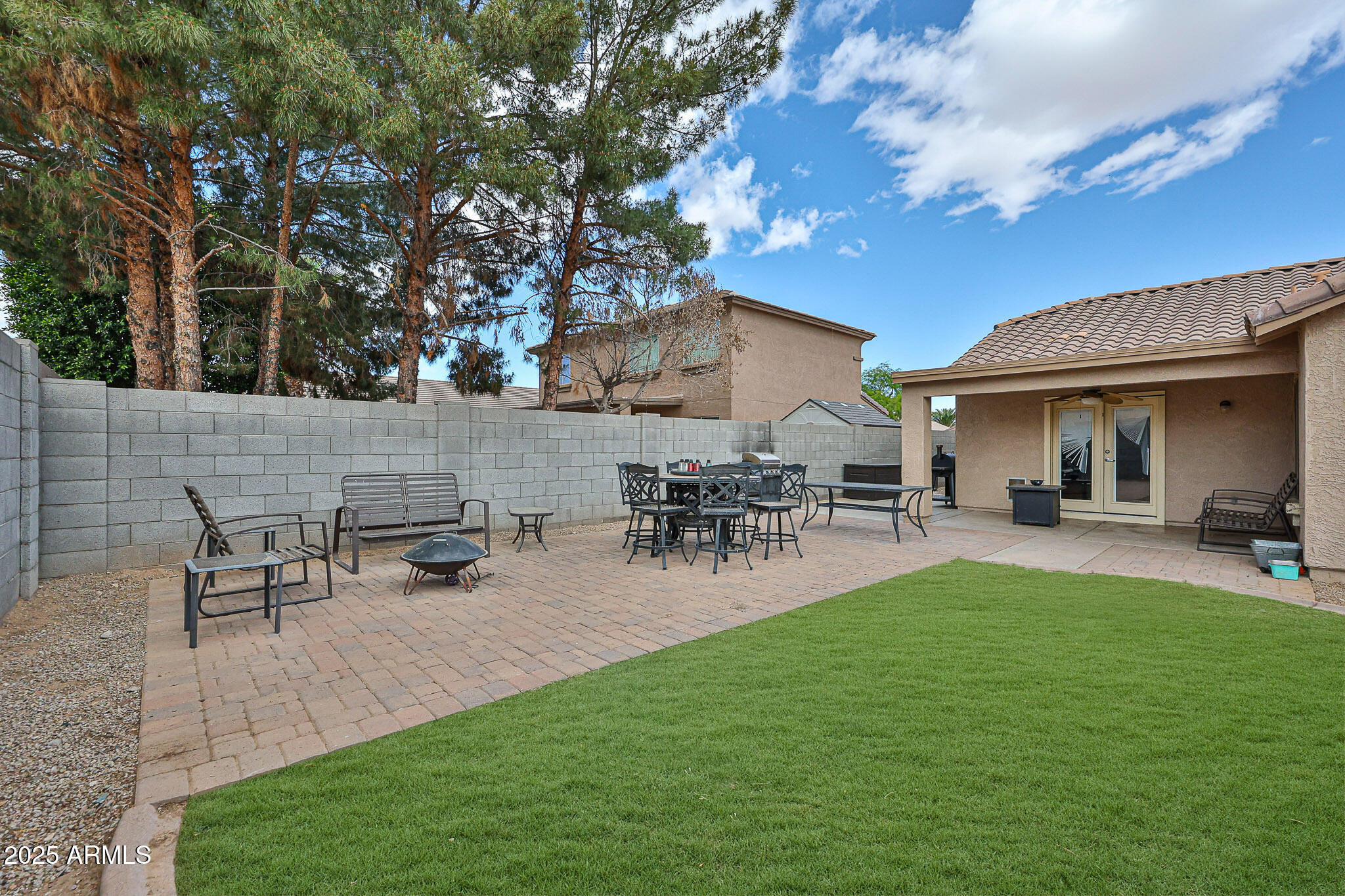 17845 West Calavar Road Surprise, AZ 85388 - Photo 22 of 26 a view of a house with patio and a garden