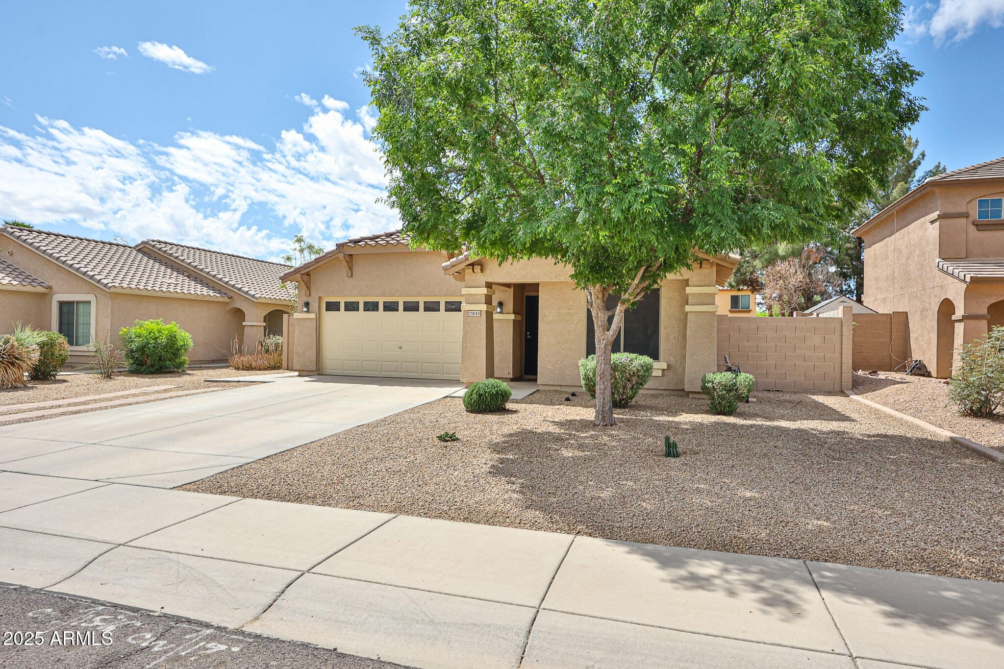 17845 West Calavar Road Surprise, AZ 85388 - Photo 2 of 26 a front view of a house with a yard and garage