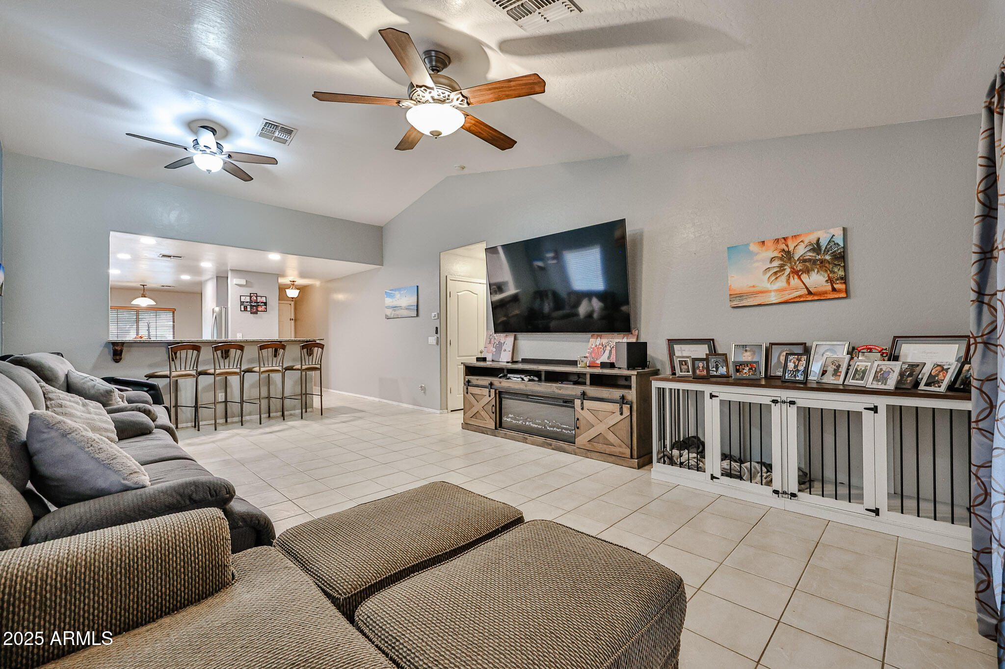 17845 West Calavar Road Surprise, AZ 85388 - Photo 4 of 26 a living room with furniture and a flat screen tv