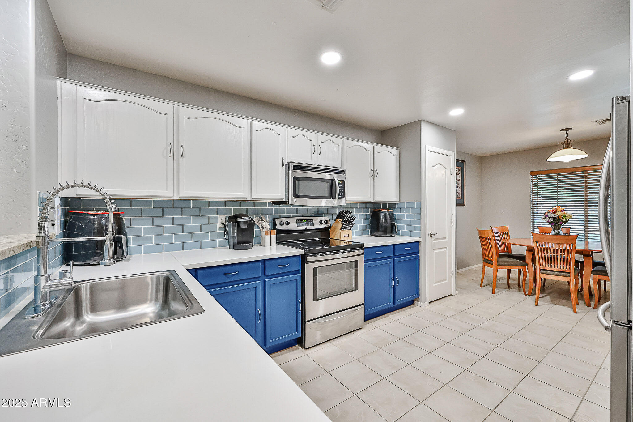 17845 West Calavar Road Surprise, AZ 85388 - Photo 6 of 26 a kitchen with granite countertop a sink and appliances