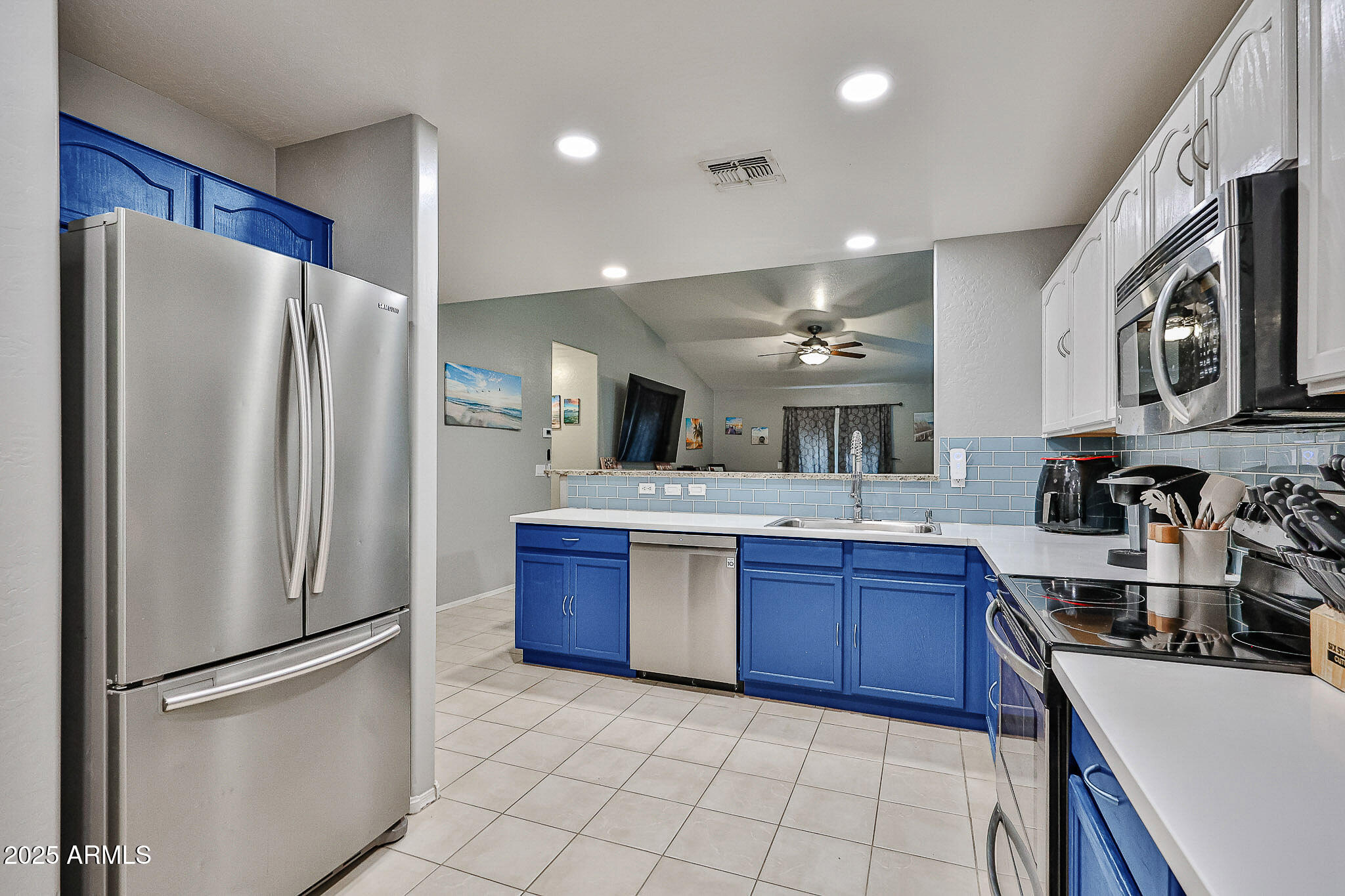 17845 West Calavar Road Surprise, AZ 85388 - Photo 8 of 26 a kitchen with stainless steel appliances granite countertop a refrigerator stove and sink