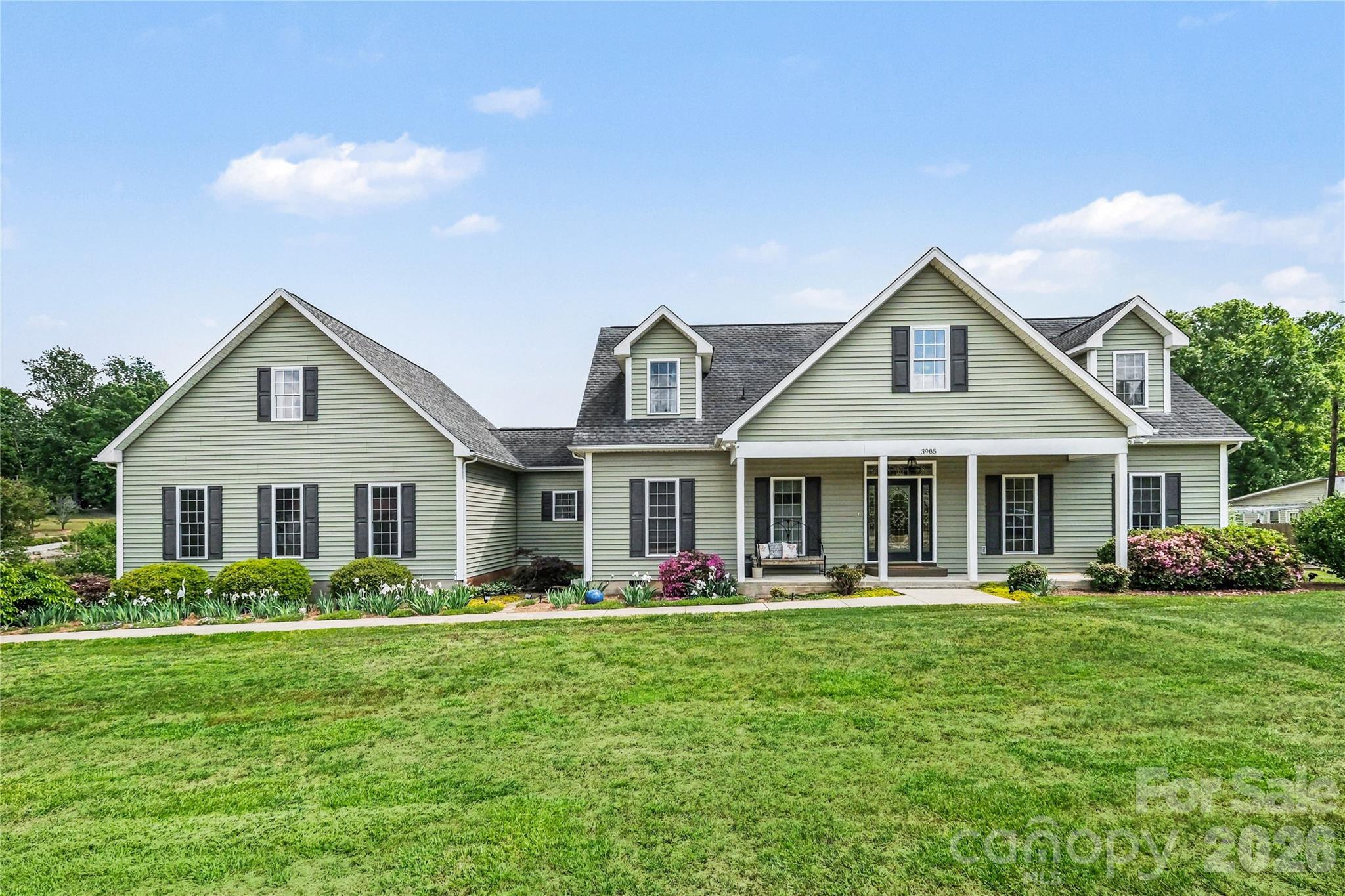 a front view of house with yard and green space