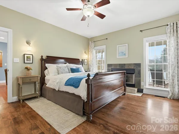 a bed room with a bed and a ceiling fan