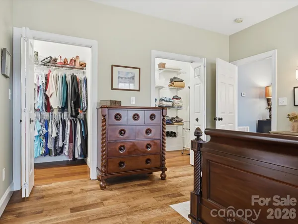 a view of walk in closet with clothes and shoes