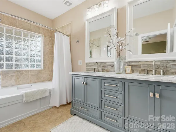 a bathroom with a granite countertop sink mirror and a