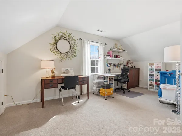 a bedroom with bed and a chandelier