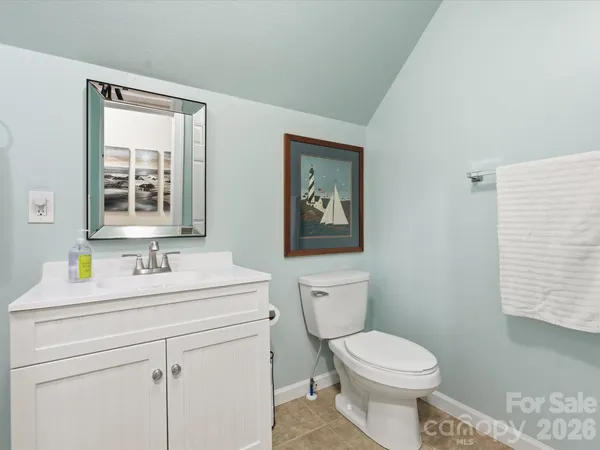 a bathroom with a shower sink and mirror