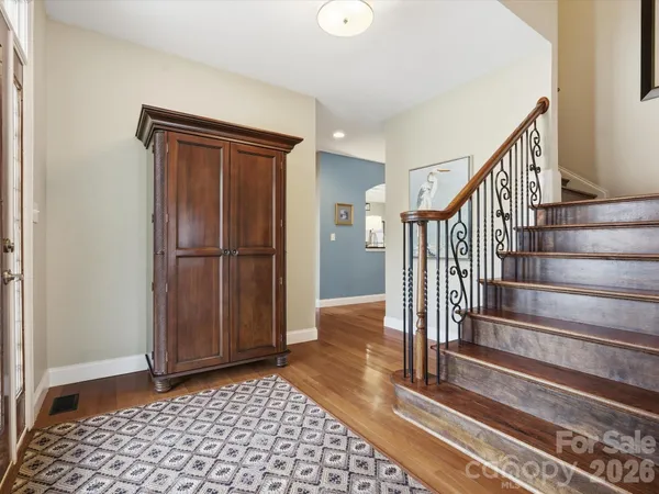 a view of entryway with wooden floor and stairs