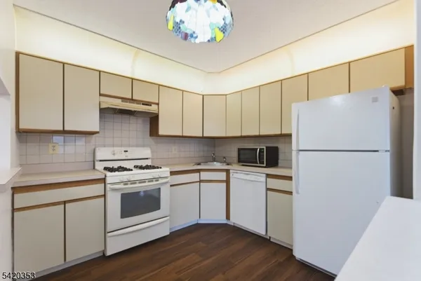 a kitchen with a white cabinets and white appliances