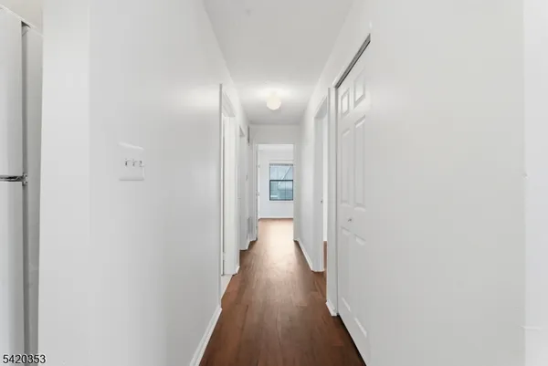 a view of hallway with wooden floor