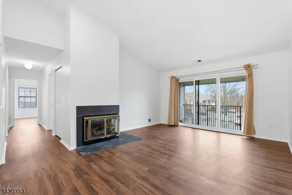 wooden floor fireplace and natural light in room