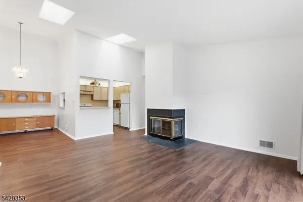 a view of an empty room with a kitchen and a sink