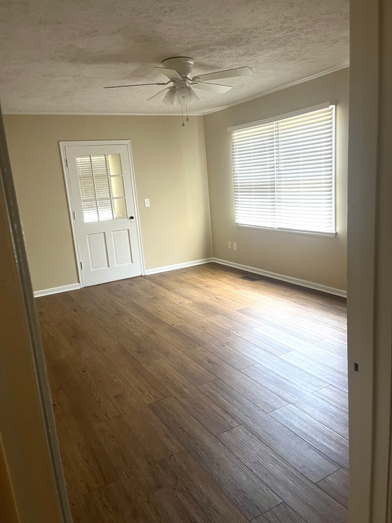 2807 Marion Street Columbus, GA 31906 - Photo 5 of 10 an empty room with wooden floor and windows
