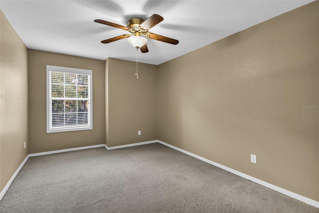 1425 Riviera Drive Kissimmee, FL 34744 - Photo 44 of 82 an empty room with a ceiling fan and window