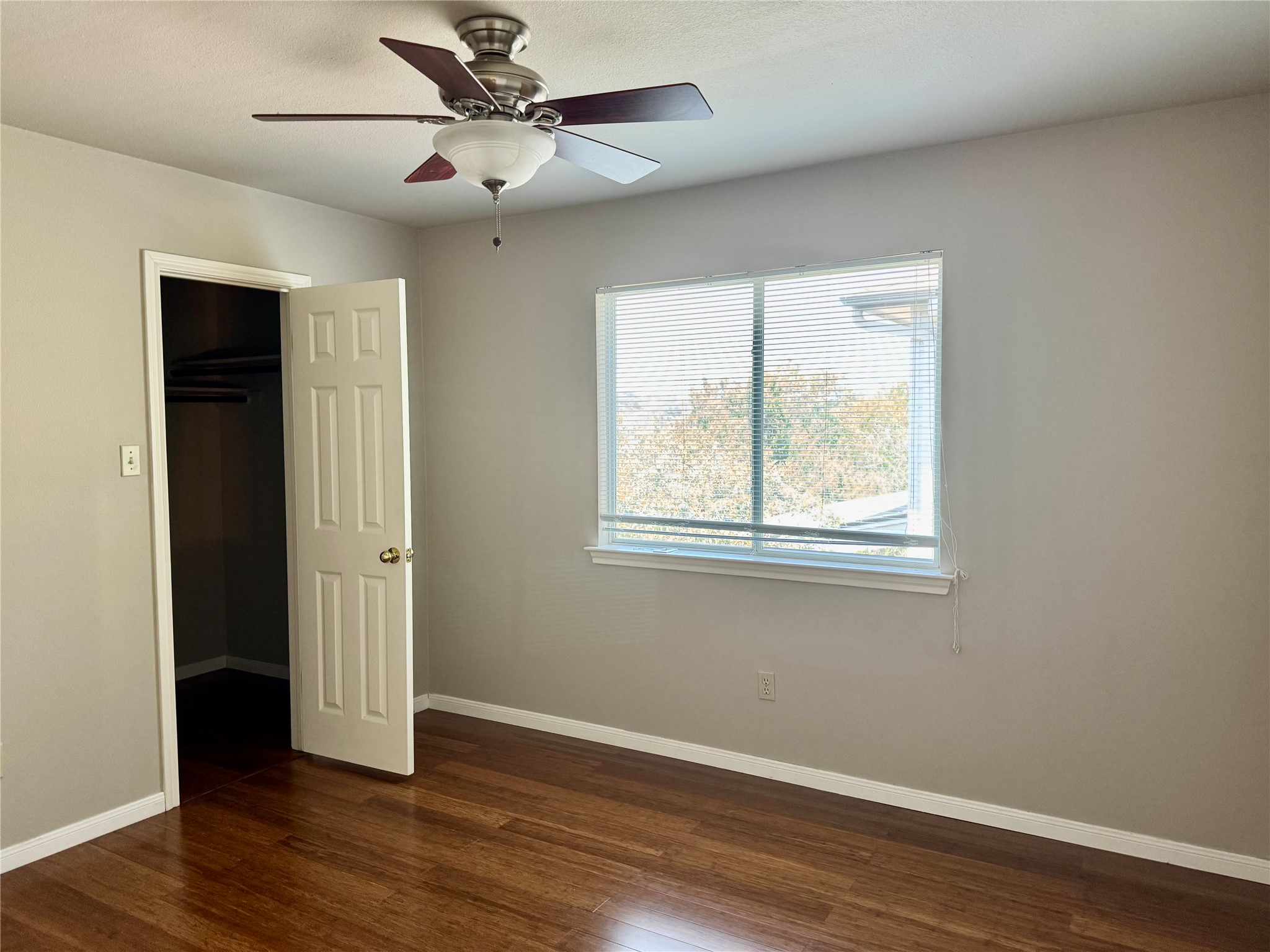 5817 Taylor Draper Cove Austin, TX 78759 - Photo 15 of 28 a view of an empty room with wooden floor and a window