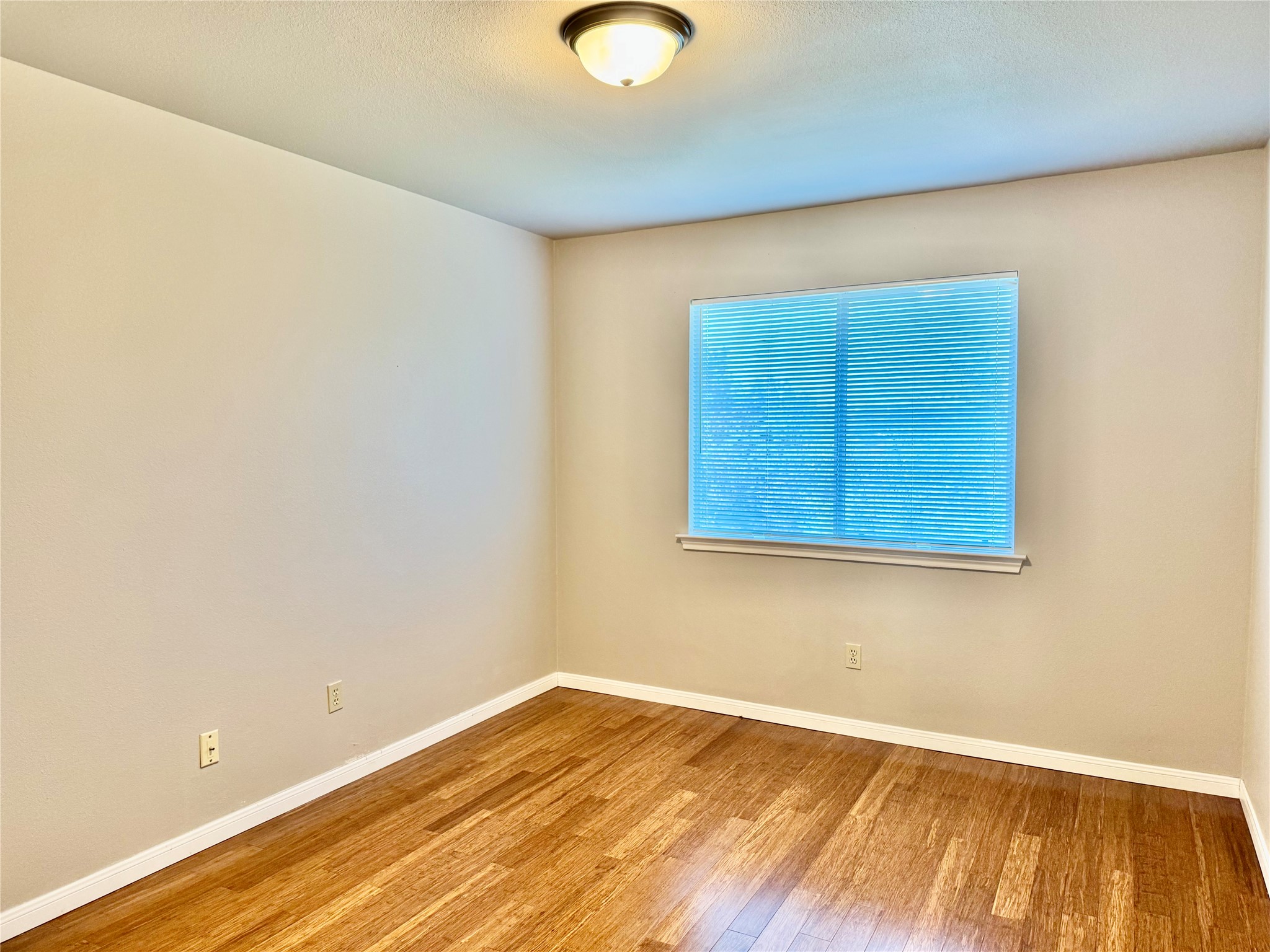 5817 Taylor Draper Cove Austin, TX 78759 - Photo 16 of 28 a view of an empty room with wooden floor and a window