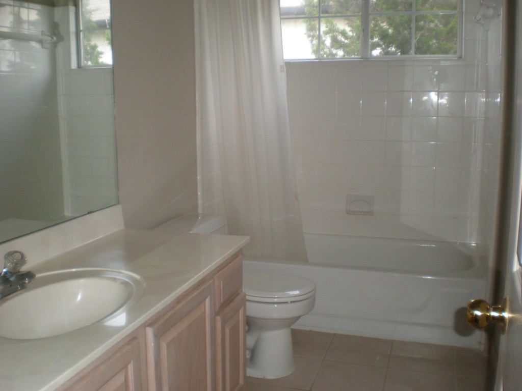 5817 Taylor Draper Cove Austin, TX 78759 - Photo 20 of 28 a bathroom with a granite countertop sink a toilet and shower