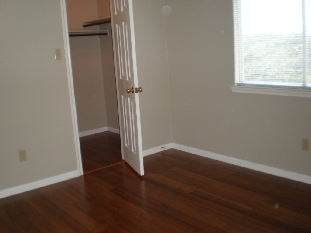 5817 Taylor Draper Cove Austin, TX 78759 - Photo 21 of 28 an empty room with wooden floor and windows