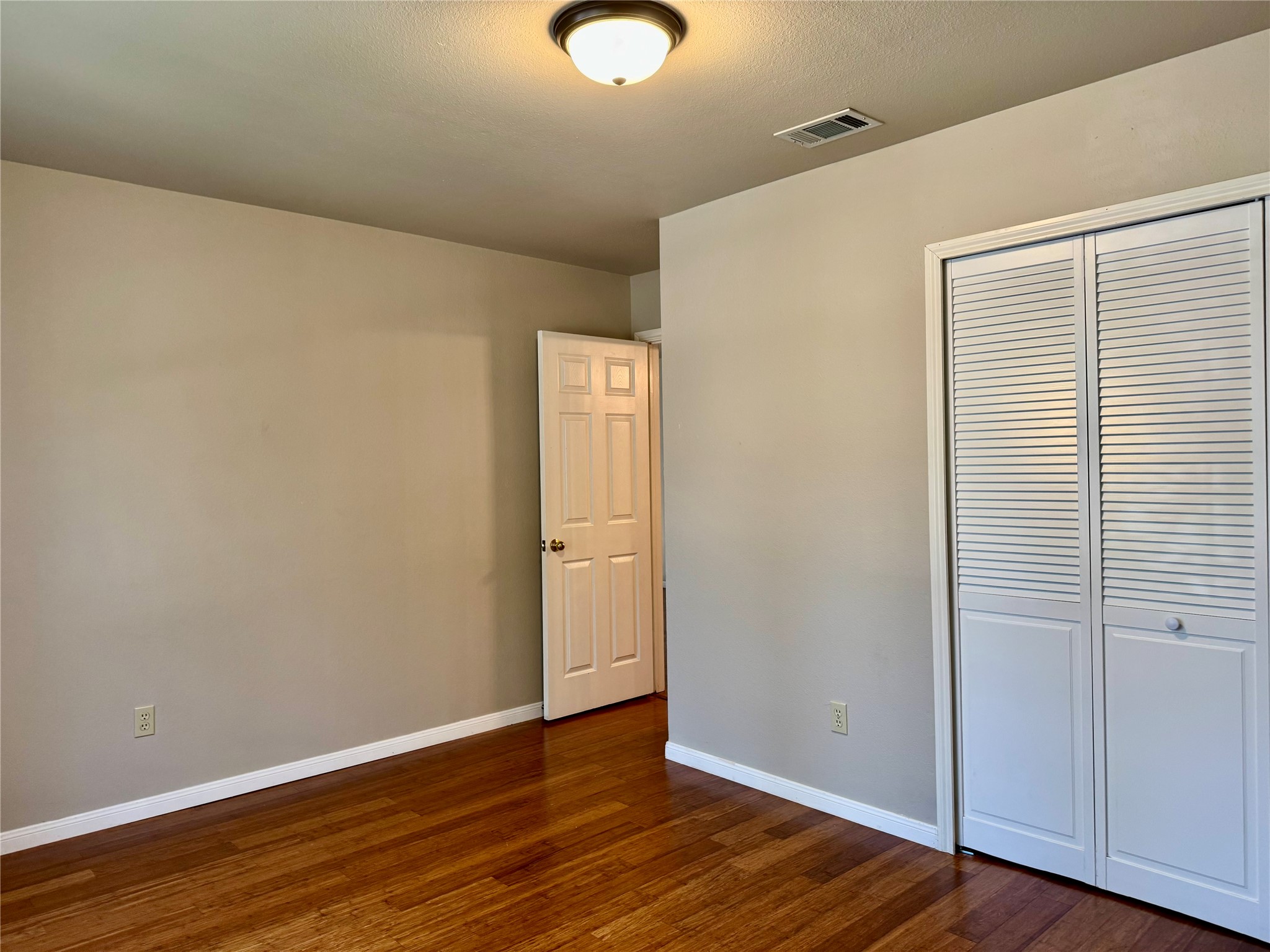 5817 Taylor Draper Cove Austin, TX 78759 - Photo 25 of 28 a view of an empty room with wooden floor