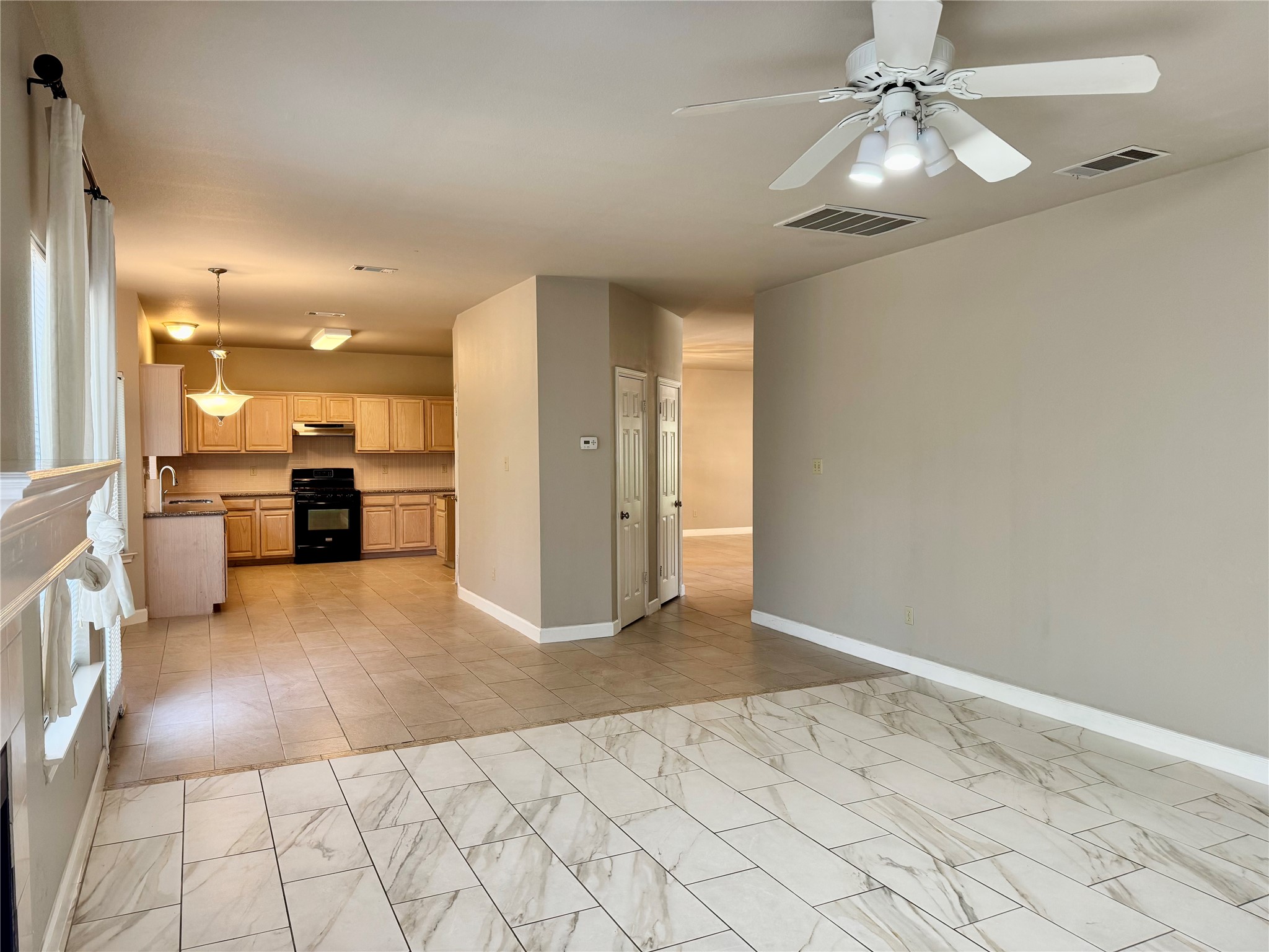 5817 Taylor Draper Cove Austin, TX 78759 - Photo 4 of 28 a view of a kitchen with furniture and a chandelier fan