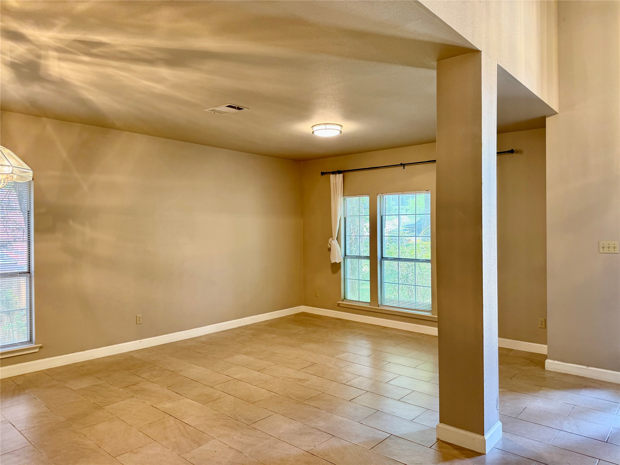 5817 Taylor Draper Cove Austin, TX 78759 - Photo 6 of 28 an empty room with wooden floor and windows