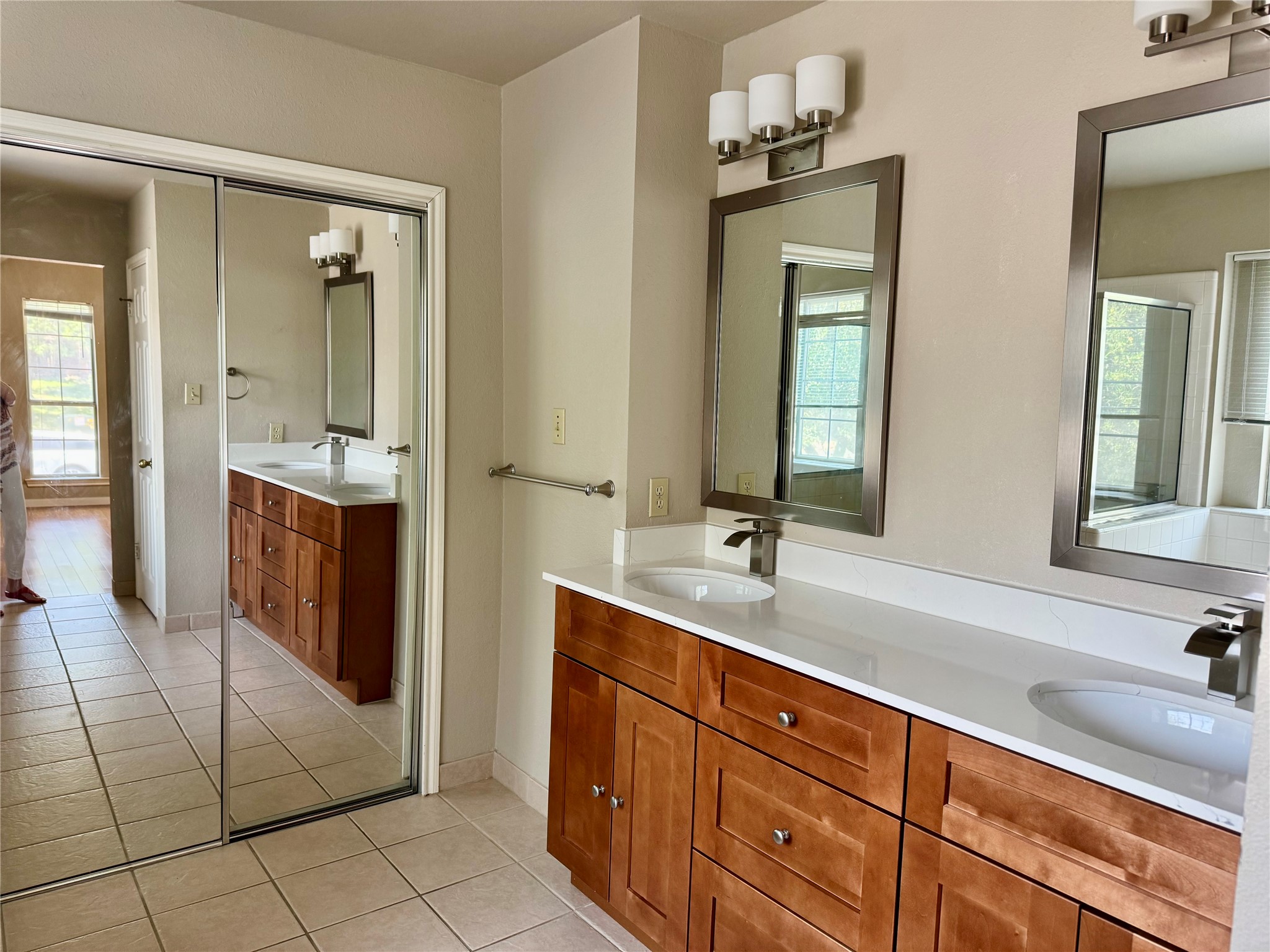 5817 Taylor Draper Cove Austin, TX 78759 - Photo 10 of 28 a spacious bathroom with a double vanity sink and mirror