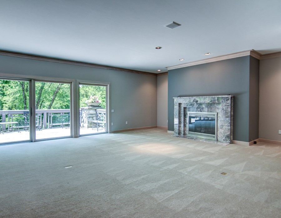 2774 Spring Creek Road Rockford, IL 61107 - Photo 6 of 25 a view of an empty room with a fireplace and a window