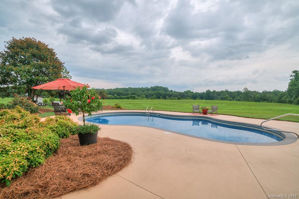 3575 Landrum Road Columbus, NC 28722 - Photo 22 of 24 a view of swimming pool with a yard and seating area
