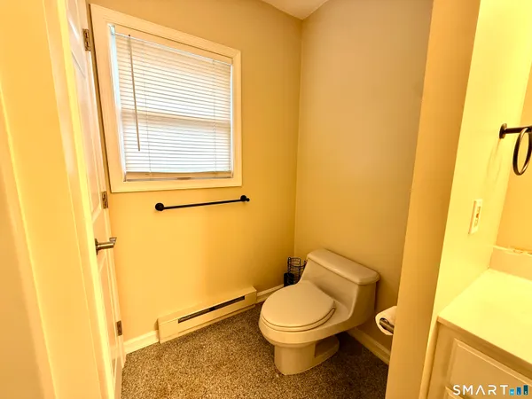 a white toilet sitting next to a sink