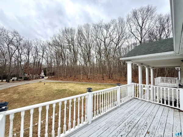 a view of a house with backyard and deck