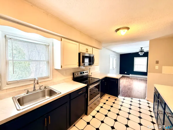 a kitchen with a sink stove and refrigerator