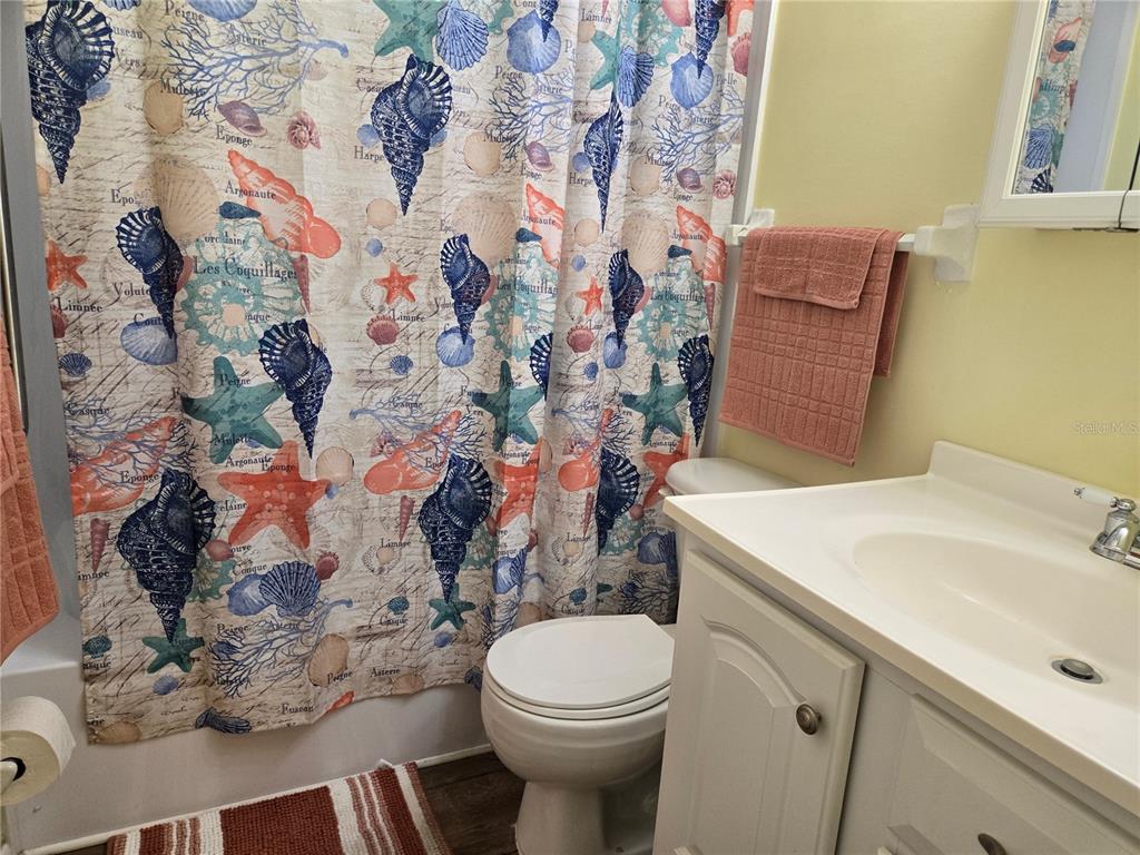 5925 Terrace Park Drive North, Unit 106 St. Petersburg, FL 33709 - Photo 11 of 22 a bathroom with a sink toilet and mirror