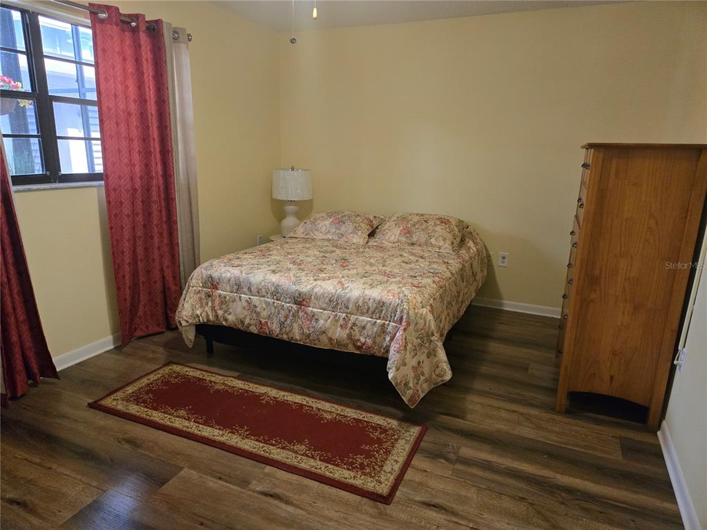 5925 Terrace Park Drive North, Unit 106 St. Petersburg, FL 33709 - Photo 13 of 22 a bedroom with a bed and a window
