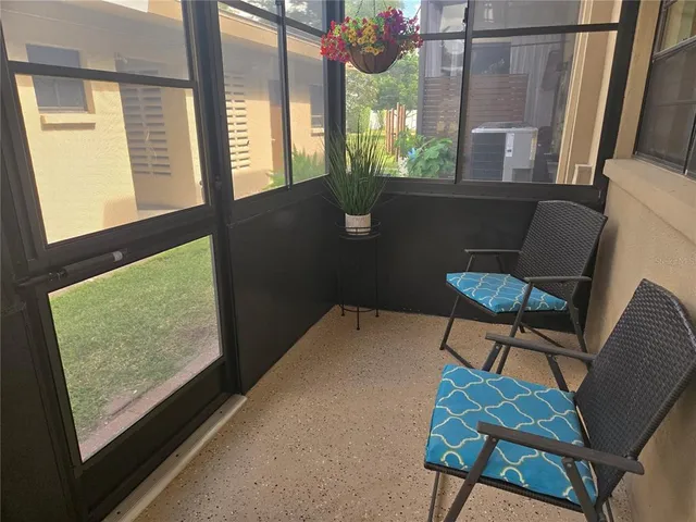 a view of a chairs and table in a balcony
