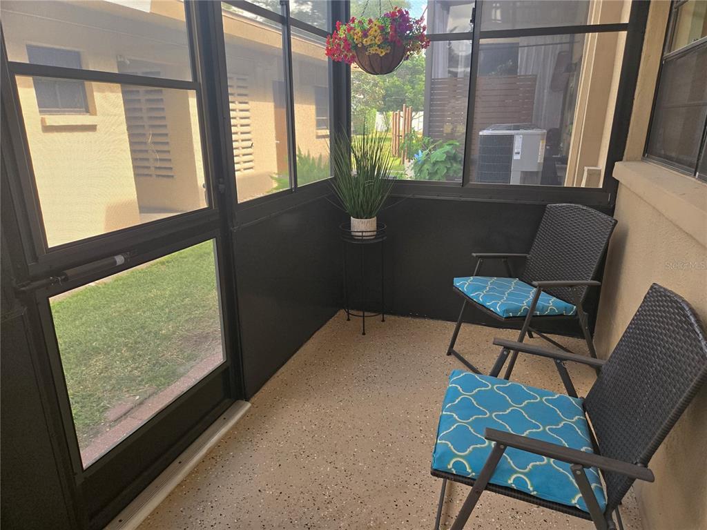 5925 Terrace Park Drive North, Unit 106 St. Petersburg, FL 33709 - Photo 17 of 22 a view of a chairs and table in a balcony