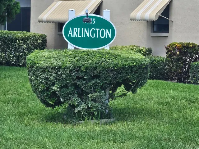 a sign of golf club on a wall under a large window