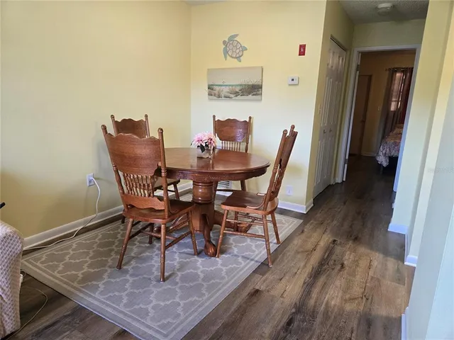 a dining room with furniture and wooden floor